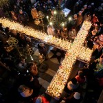 Worshippers gather around candles stuck to jars of honey, arranged as a cross, during mass for the 'sanctification of honey' at the Presentation of the Blessed Virgin church in the town of Blagoevgrad, Bulgaria