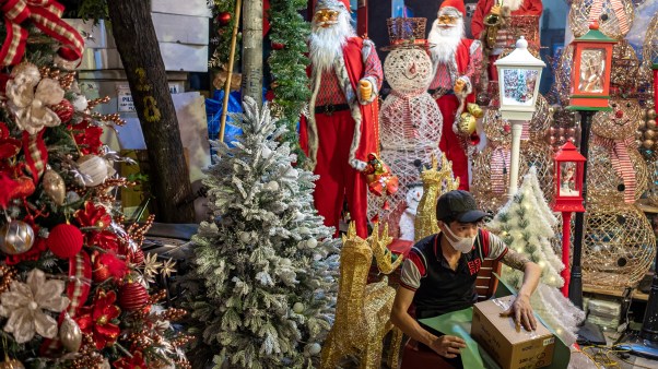 A vendor prepares a box of Christmas gifts in Hanoi, Vietnam.