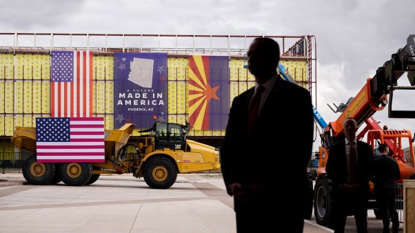 U.S. Secret Service agents stand guard as President Joe Biden tours a computer chip plant in Phoenix for Taiwan Semiconductor Manufacturing Company.