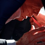 Former President Donald Trump is covered by U.S. Secret Service agents after an assassination attempt during a rally in Pennsylvania.