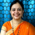 Surinder Kaur in front of a blue dotted cloth