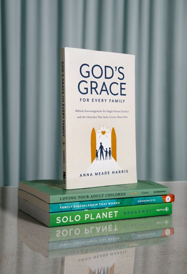 Photograph of "God's Grace" book on a stack of books with a blue background