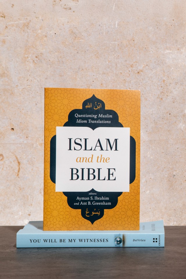 Photograph of "Islam and the Bible" book on a stack of books with a marble background