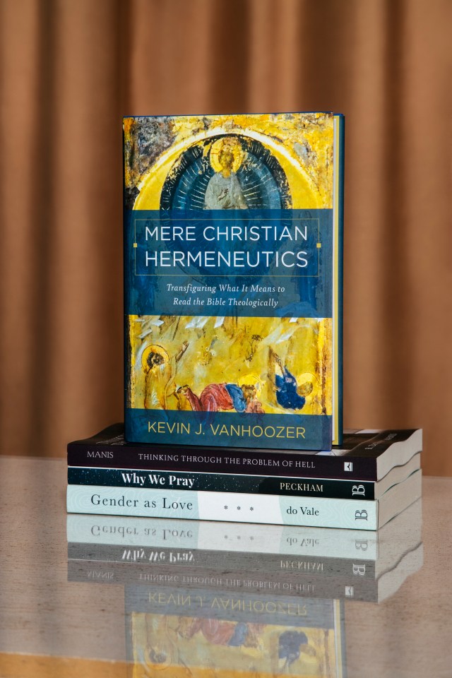 Photograph of "mere Christian hermeneutics" book on a stack of books with a orange background