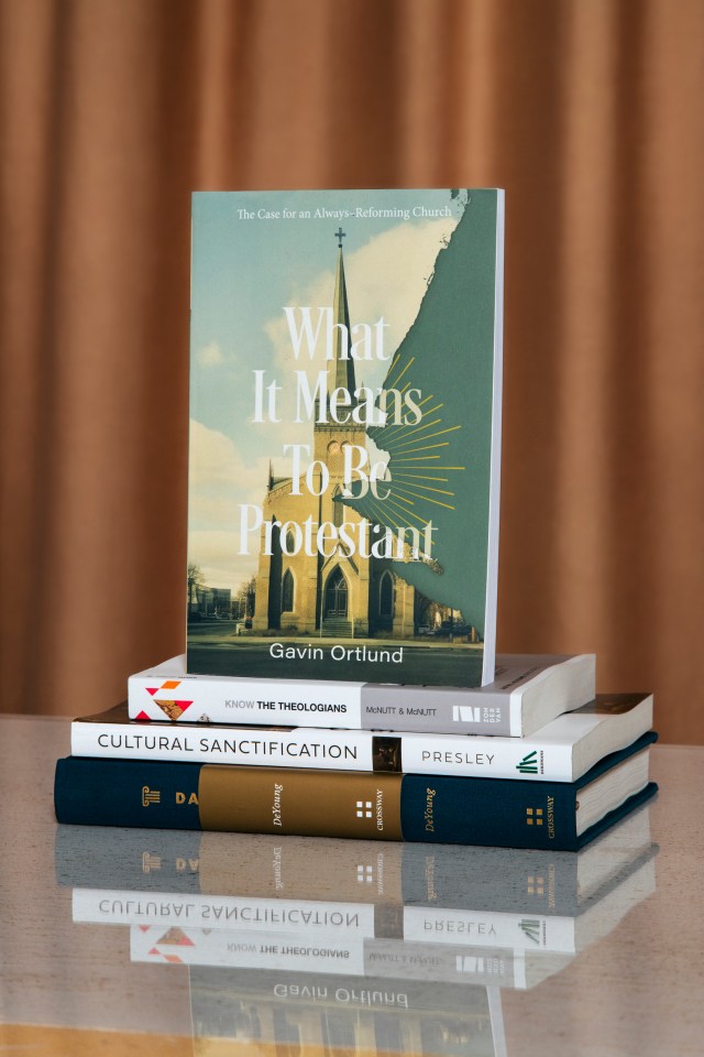 Photograph of "What it means to be protestant" book on a stack of books with a orange background