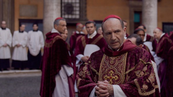 Ralph Fiennes stars as Cardinal Lawrence among other clergy in Conclave
