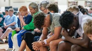 Attendees pray at Clayton Baptist Church