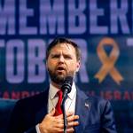 JD Vance places his hand on his chest speaking in front of a screen that reads "Remembering October 7"