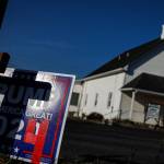 Trump 2024 campaign sign in front of a church with a cross