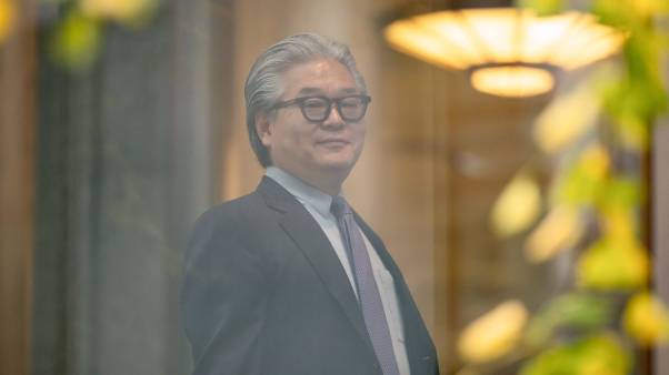 Bill Hwang, founder of Archegos Capital Management, arrives at federal court in New York, US, on Wednesday, Nov. 20, 2024. He is a grey-haired man wearing thick glasses and a suit with a purple tie.