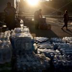 Volunteers gather water to distribute after Helene knocked out running water in North Carolina