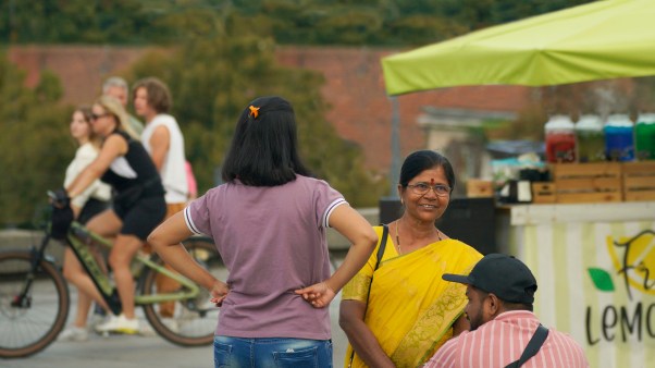 Indian family by a lemonade stand and bike riders