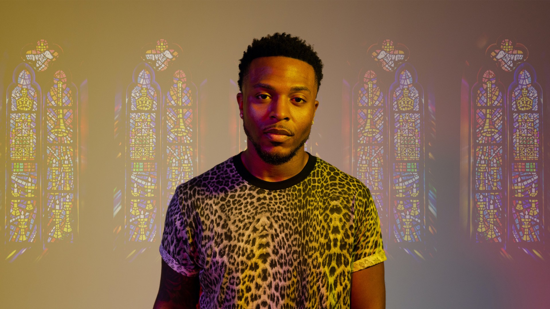 The rapper Flame with stained glass church windows in the background.