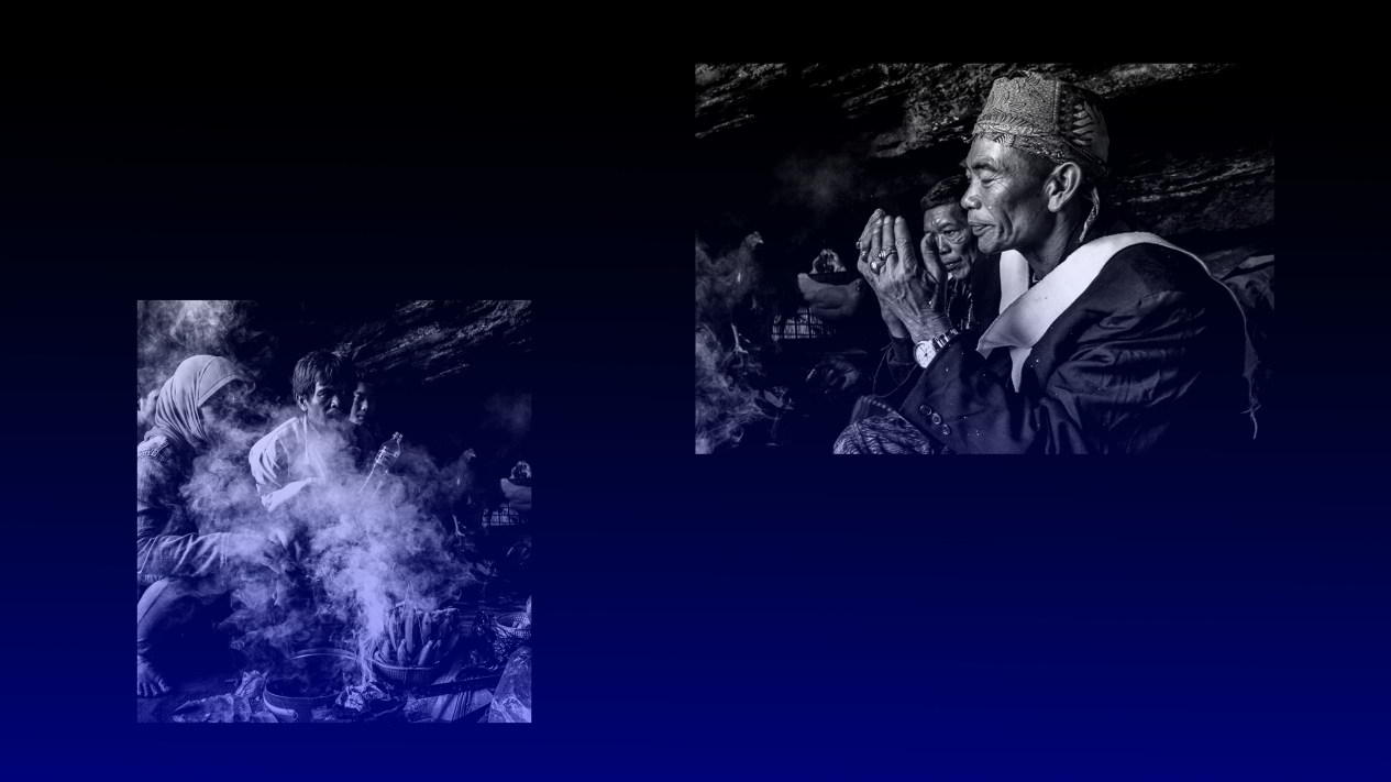 People sitting in smoke with a shaman praying