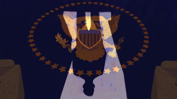 The shadow of a man over the presidential seal rug in the White House.