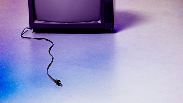 An unplugged TV sitting on the ground