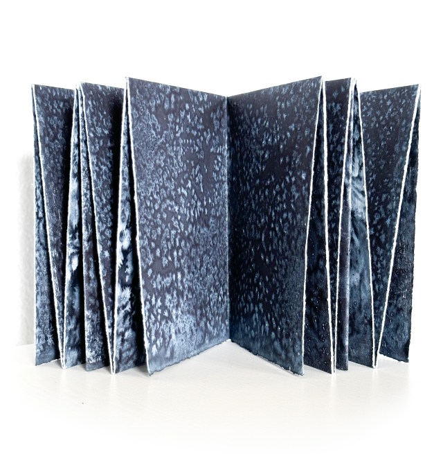 Book made of folded papers with blue and white watercolor