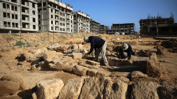 Palestinian men work excavating a Roman cemetery in Gaza City.